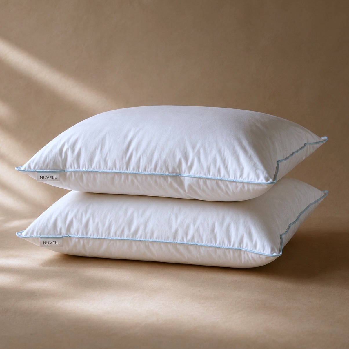 Two NUVELL Firm pillows with fuller loft and blue piping