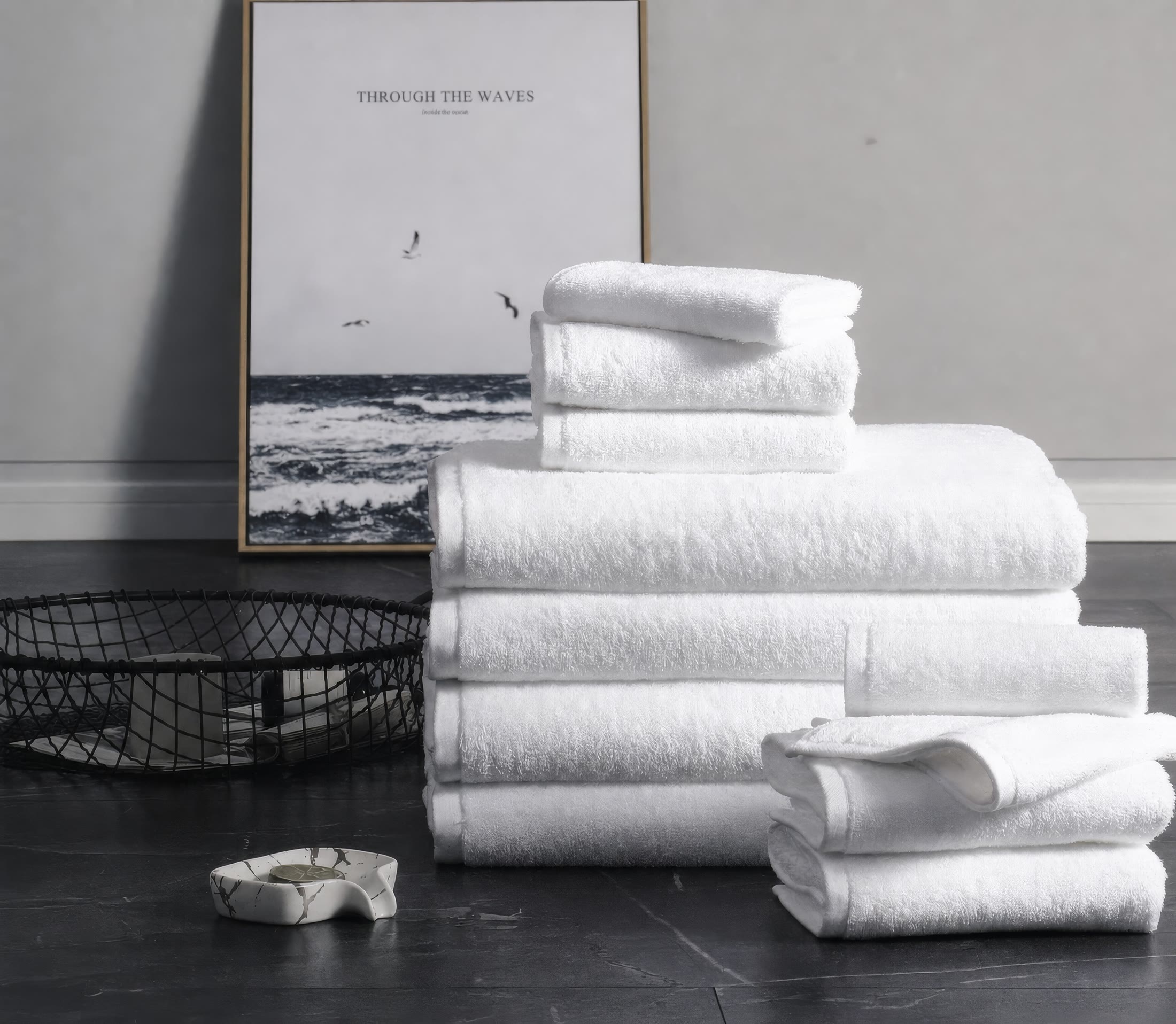 Folded white towels stacked in a calm bathroom setting