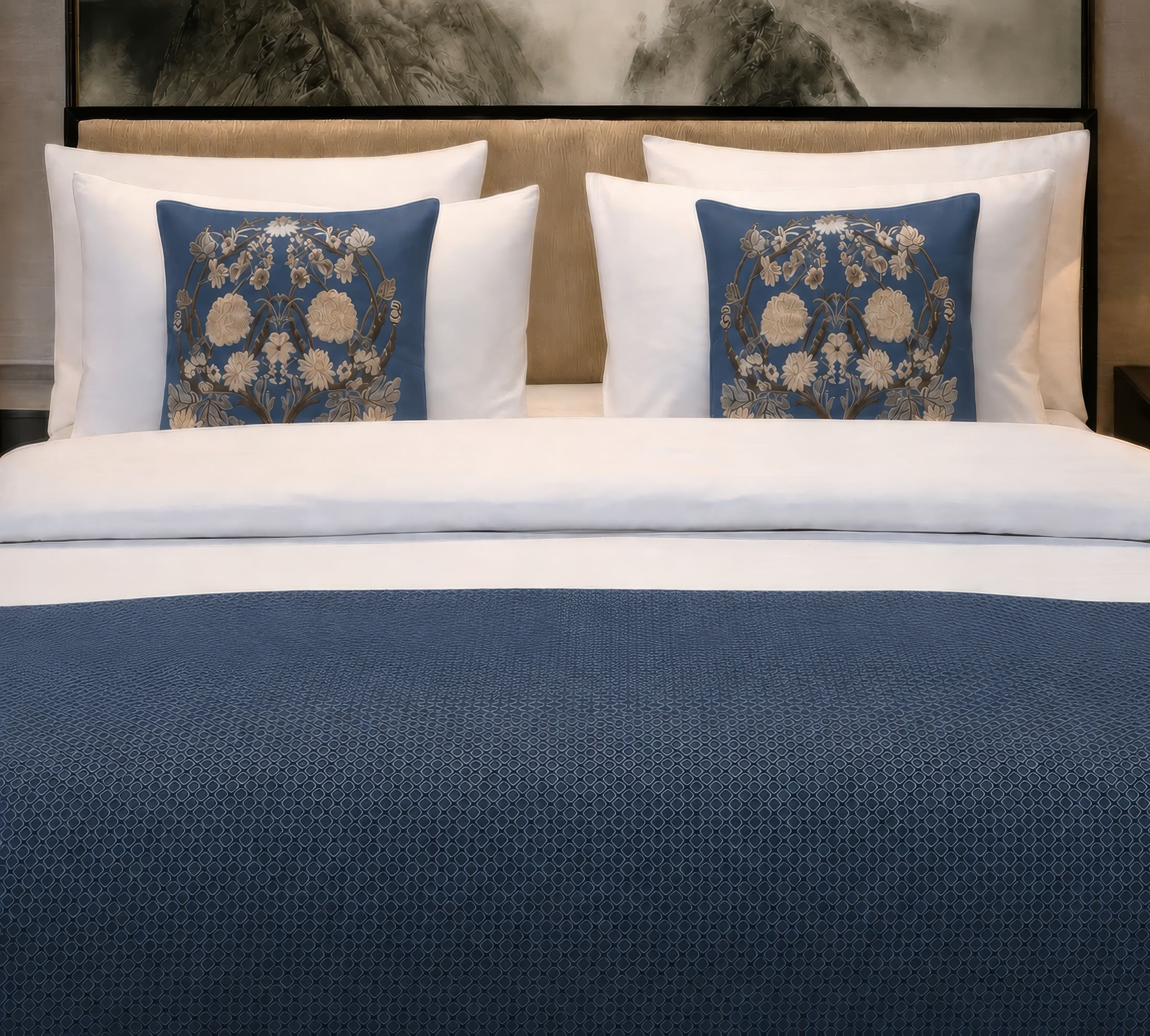 Decorative blue linen styled across a hotel bed